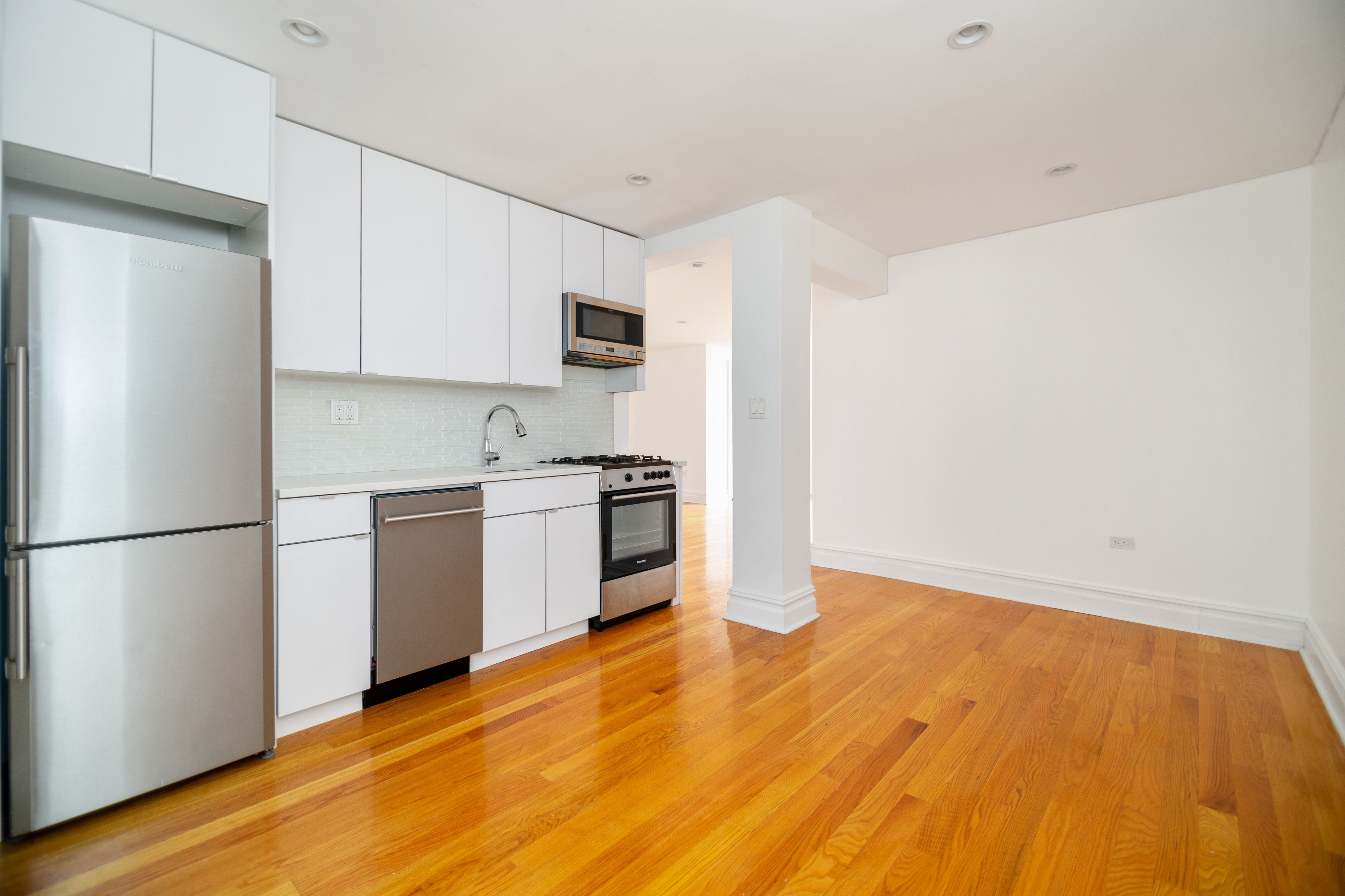 69 Bennett Avenue, Unit 608 Manhattan, NY 10033 - Photo 3 of 6 a kitchen with stainless steel appliances a refrigerator sink and microwave