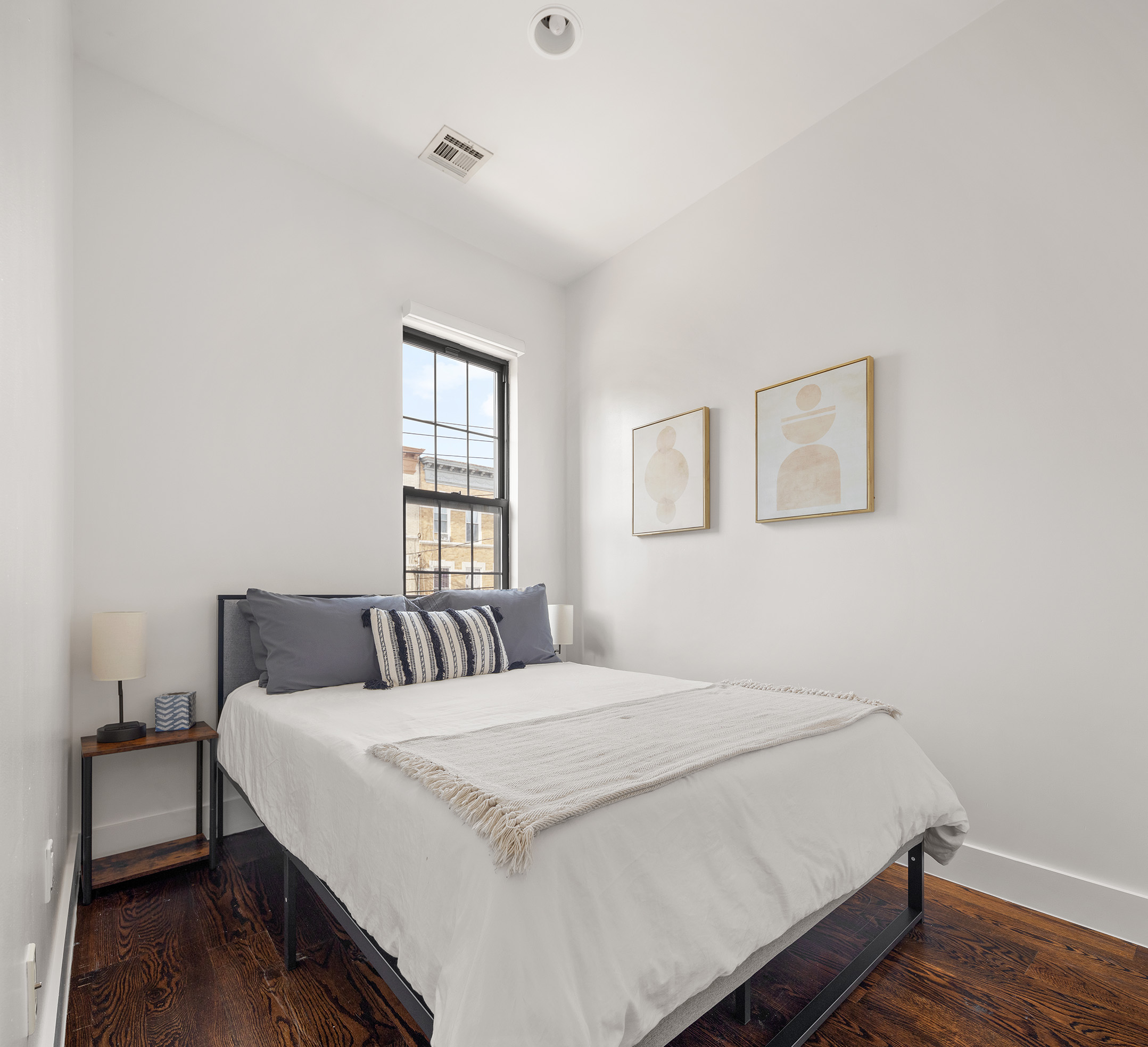 253 Wyckoff Avenue, Unit 2 Brooklyn, NY 11237 - Photo 6 of 8 a bedroom with a bed and a window
