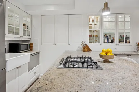 a kitchen with stainless steel appliances granite countertop a stove and a sink