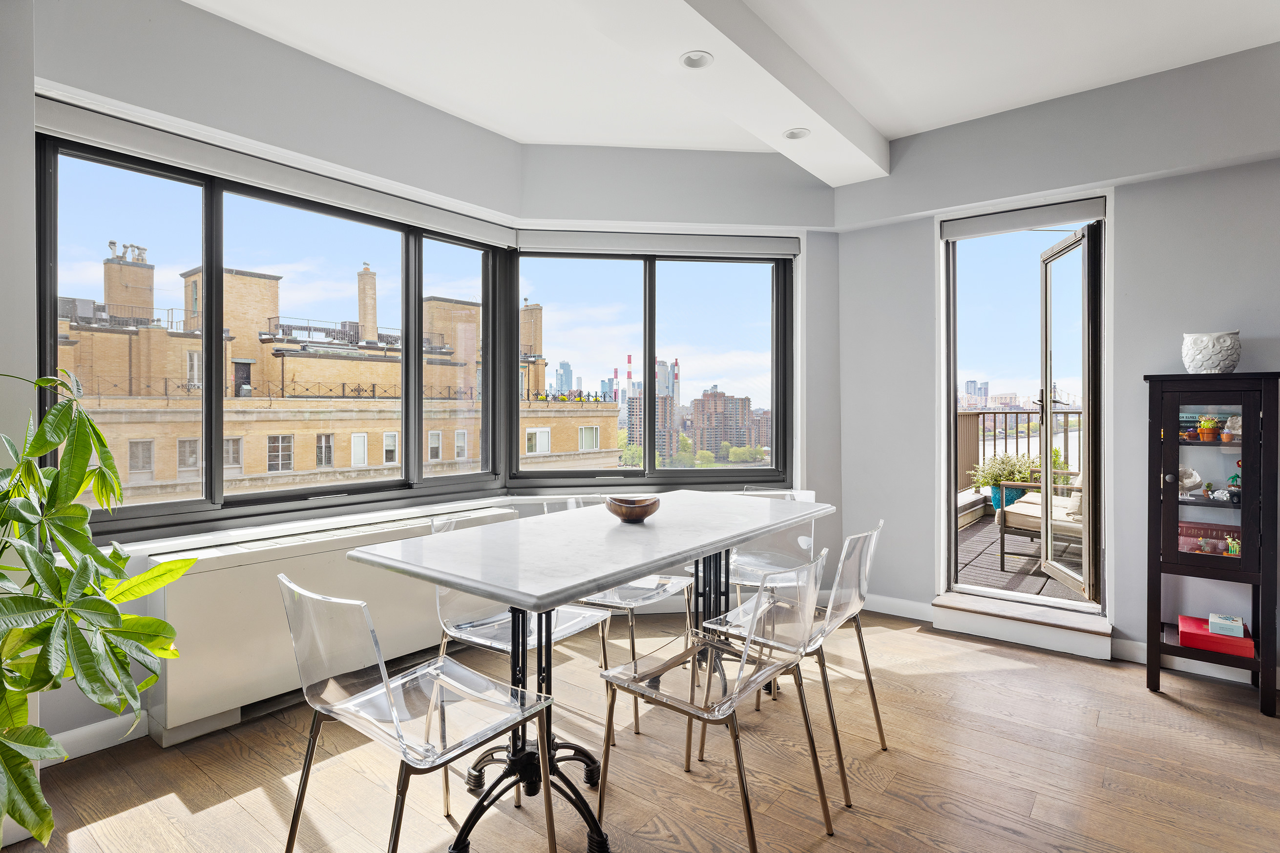 10 East End Avenue, Unit 18D Manhattan, NY 10075 - Photo 2 of 21 a dining room with furniture and large windows