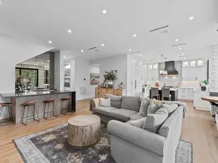 a living room with furniture and view of kitchen