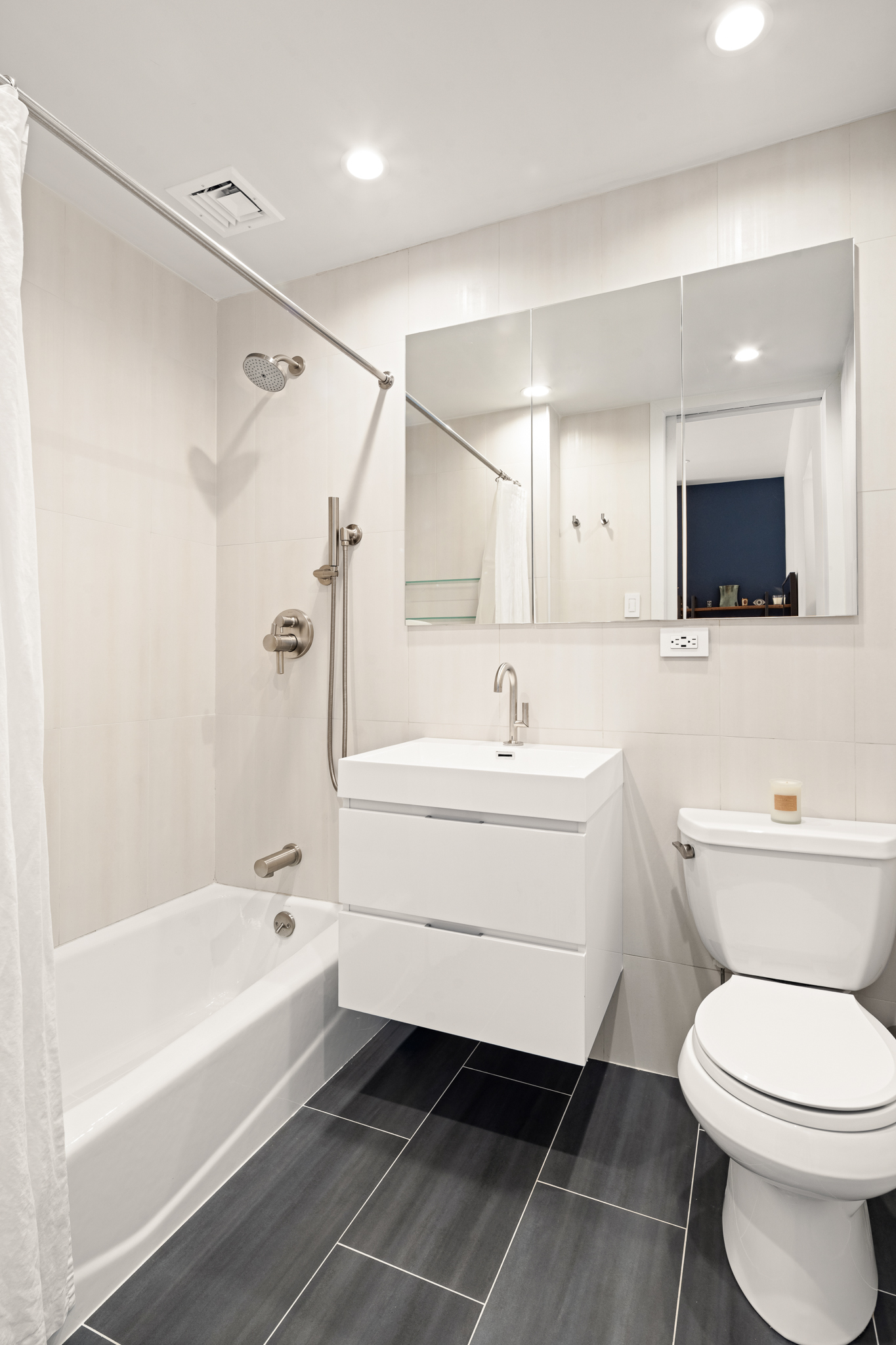 23 East 10th Street, Unit 508 Manhattan, NY 10003 - Photo 7 of 21 a bathroom with a sink a toilet and a bathtub