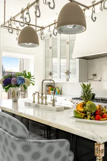 a kitchen with a sink a counter and cabinets