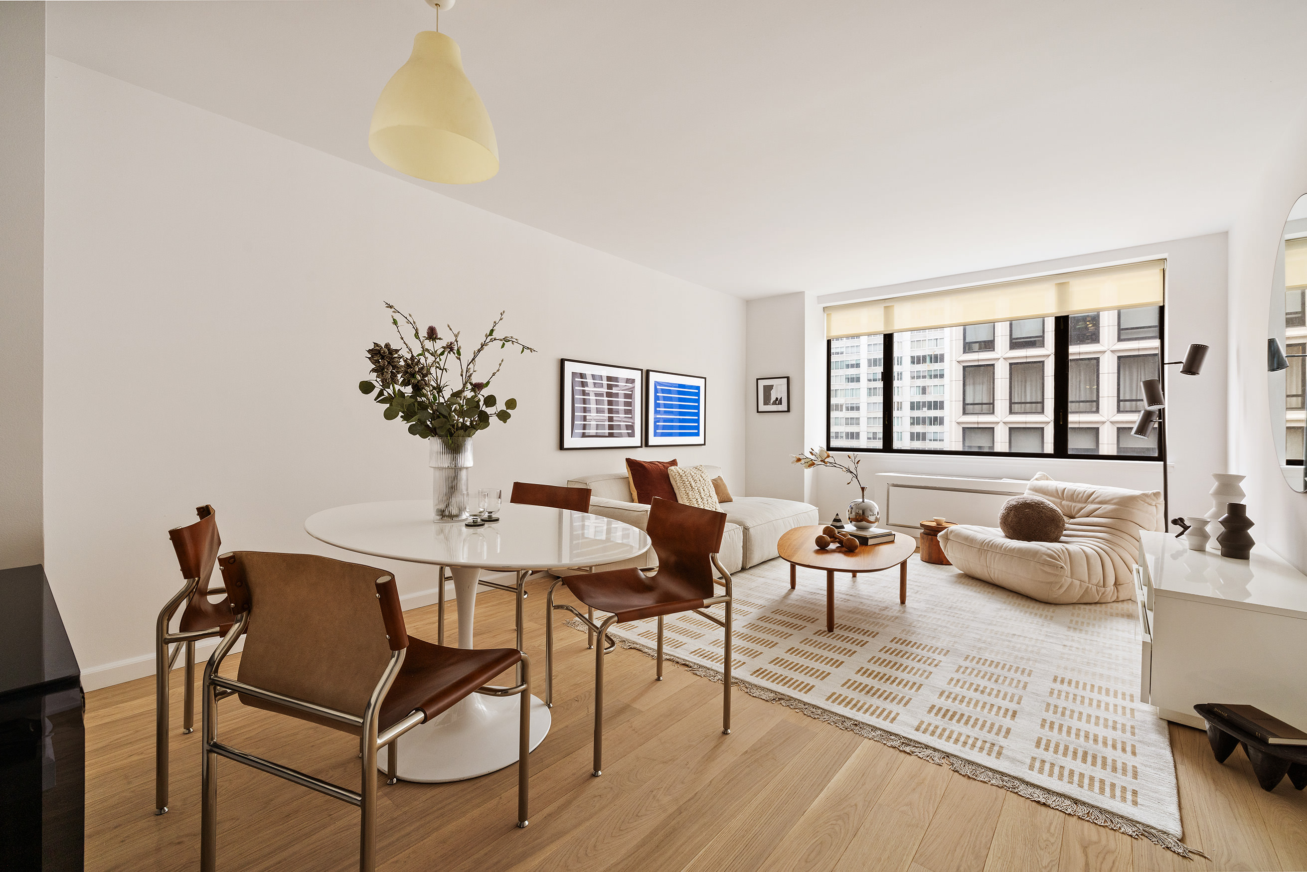 30 West 61st Street, Unit 12G Manhattan, NY 10023 - Photo 2 of 7 a view of a dining room with furniture and chandelier