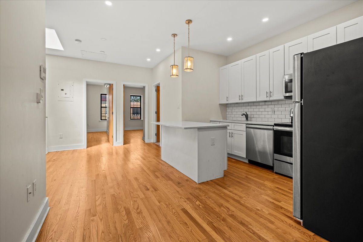 1773 Nostrand Avenue Brooklyn, NY 11226 - Photo 3 of 12 a view of a kitchen with wooden floor and a window