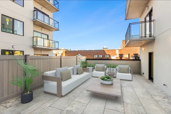 a view of a patio with couches and potted plants