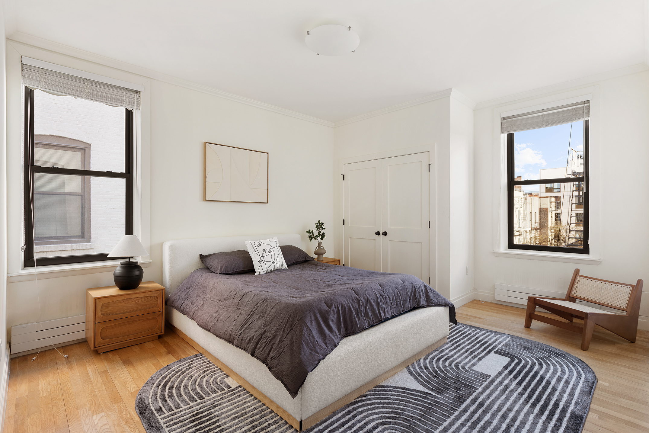 1845 Adam Clayton Powell Jr Boulevard, Unit 5C Manhattan, NY 10026 - Photo 10 of 17 a bedroom with a bed and a couch