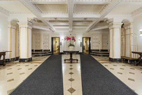 a view of a hallway with a couch and dresser