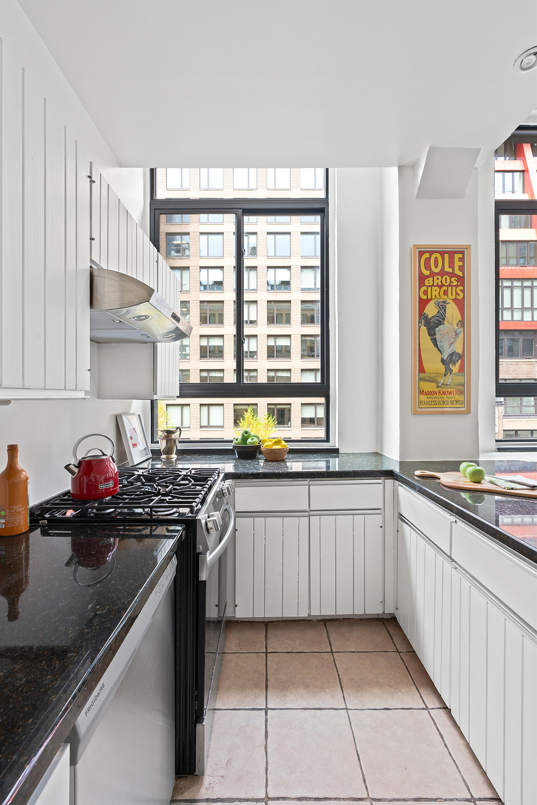 348 West 38th Street, Unit 9E Manhattan, NY 10018 - Photo 5 of 10 a kitchen with stainless steel appliances a sink stove and cabinets