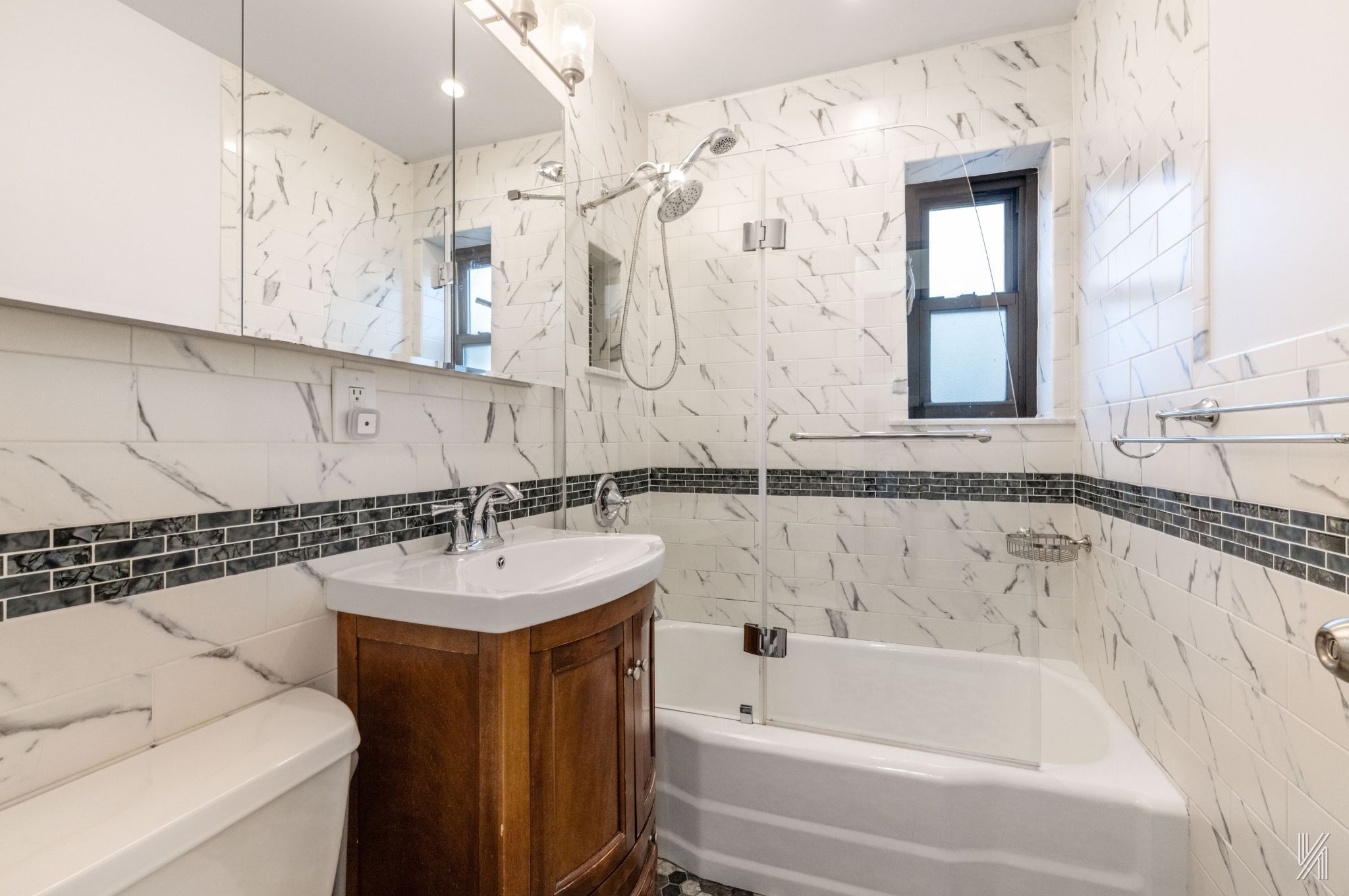 34-10 94th Street, Unit 6G Queens, NY 11372 - Photo 16 of 19 a bathroom with a bathtub sink and mirror