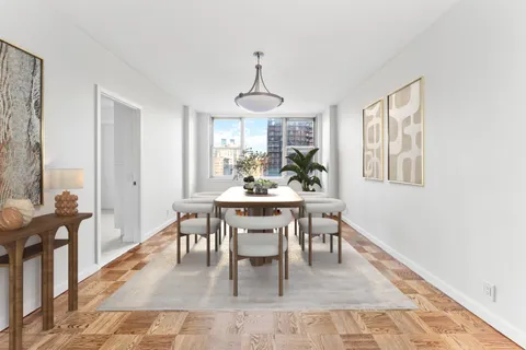 a dining room with wooden floor a chandelier a wooden table and chairs