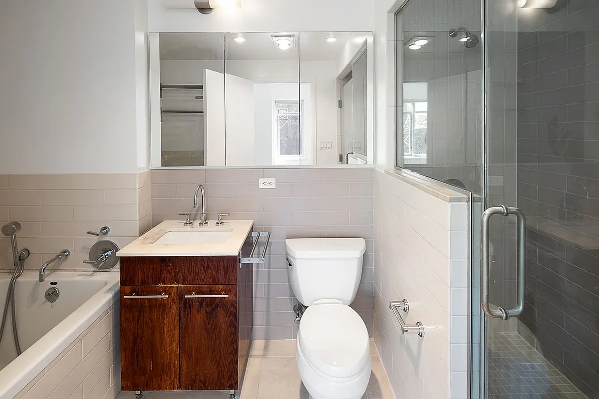 181 Clermont Avenue, Unit 101 Brooklyn, NY 11205 - Photo 7 of 9 a bathroom with a sink toilet and shower