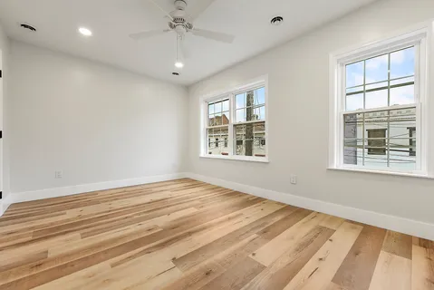 a view of a livingroom with wooden floor and closet