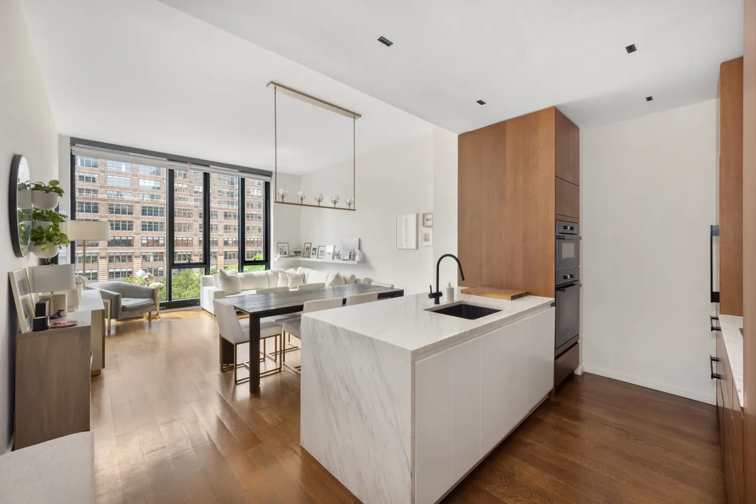 a kitchen with sink and view of living room