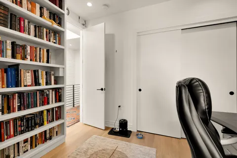 a view of a livingroom with furniture and a book shelf