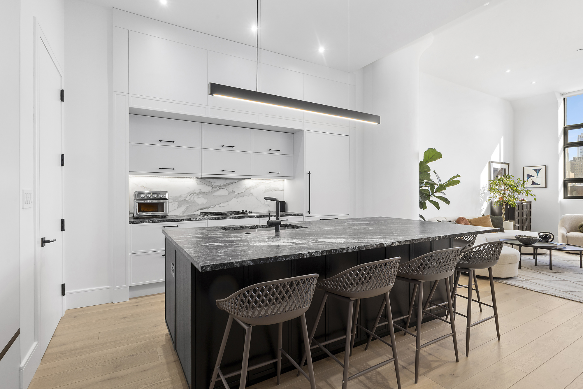 360 Furman Street, Unit 507/508 Brooklyn, NY 11201 - Photo 5 of 43 a kitchen with granite countertop a table chairs stove and cabinets