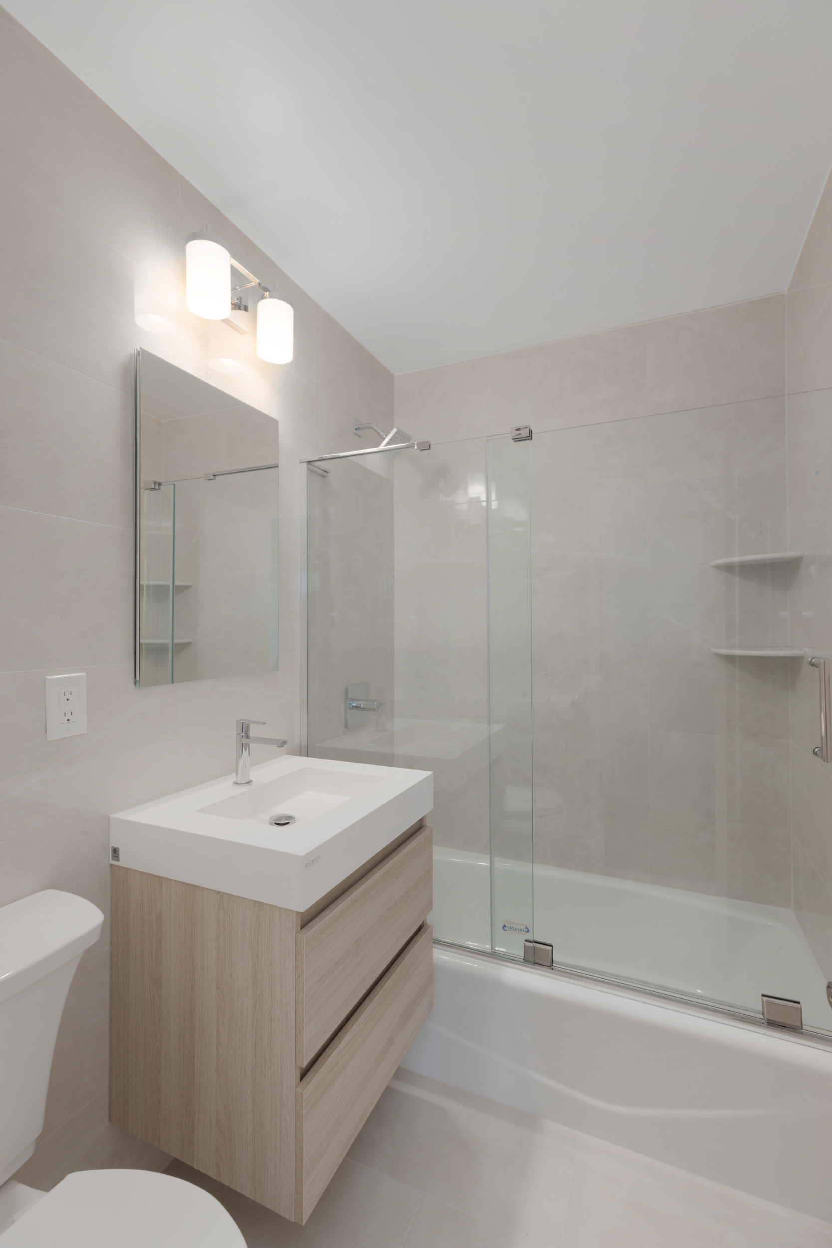 201 West 70th Street, Unit 20L Manhattan, NY 10023 - Photo 5 of 6 a bathroom with a sink a toilet and shower