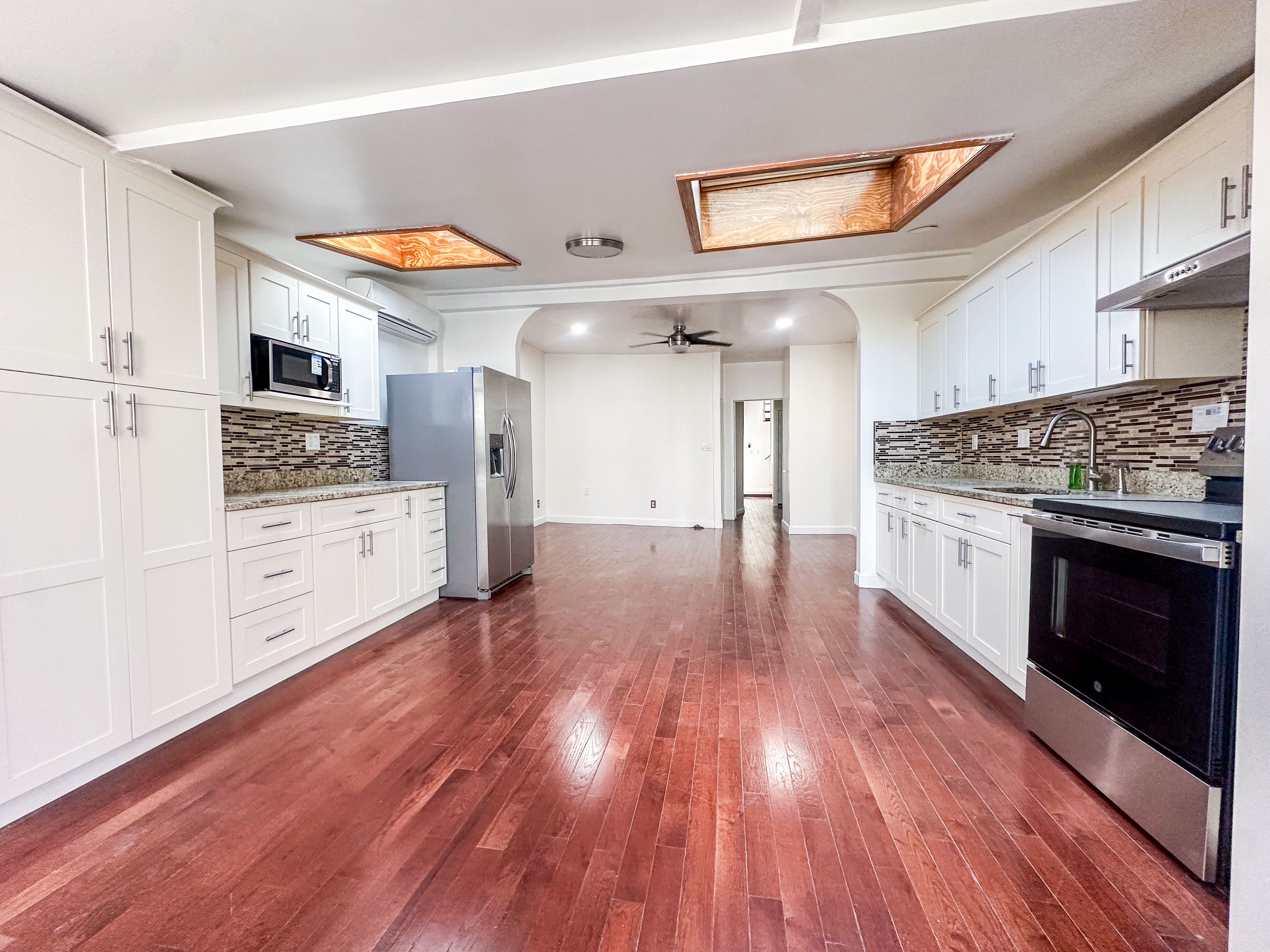 289 A Cooper Street, Unit 2 Brooklyn, NY 11237 - Photo 6 of 19 a kitchen with stainless steel appliances a stove top oven and cabinets
