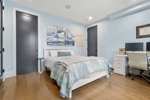 a spacious bedroom with a bed and a desk