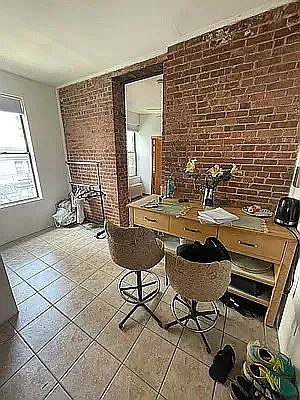 402 East 69th Street, Unit 28 Manhattan, NY 10065 - Photo 2 of 5 a balcony with chairs and table