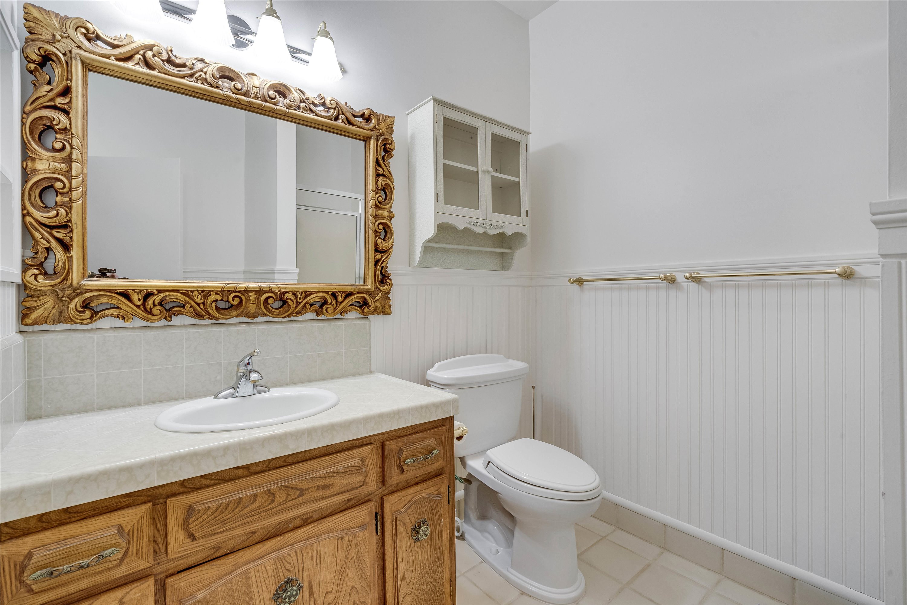 1291 Rockland Drive St. Helena, CA 94574 - Photo 17 of 26 a bathroom with a sink a mirror a toilet and shower