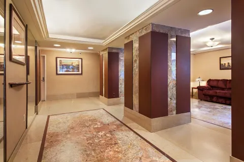a view of hallway with furniture and a large window