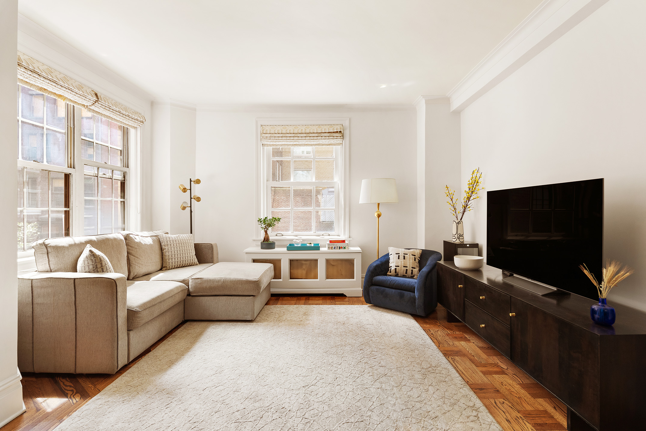 41 5th Avenue, Unit 2F Manhattan, NY 10003 - Photo 2 of 12 a living room with furniture and a flat screen tv