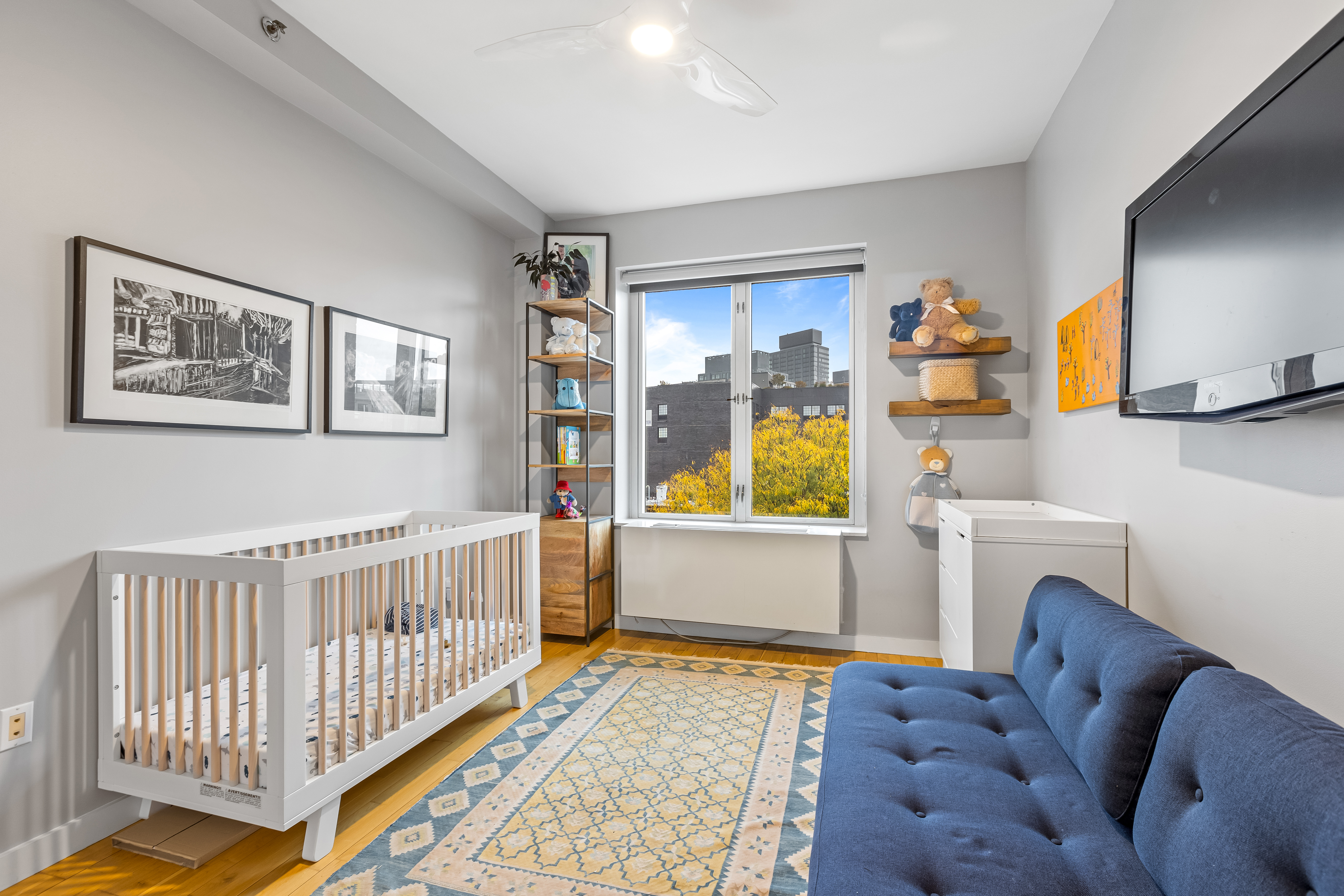 545 Washington Avenue, Unit 604 Brooklyn, NY 11238 - Photo 10 of 16 a living room with furniture and a baby crib