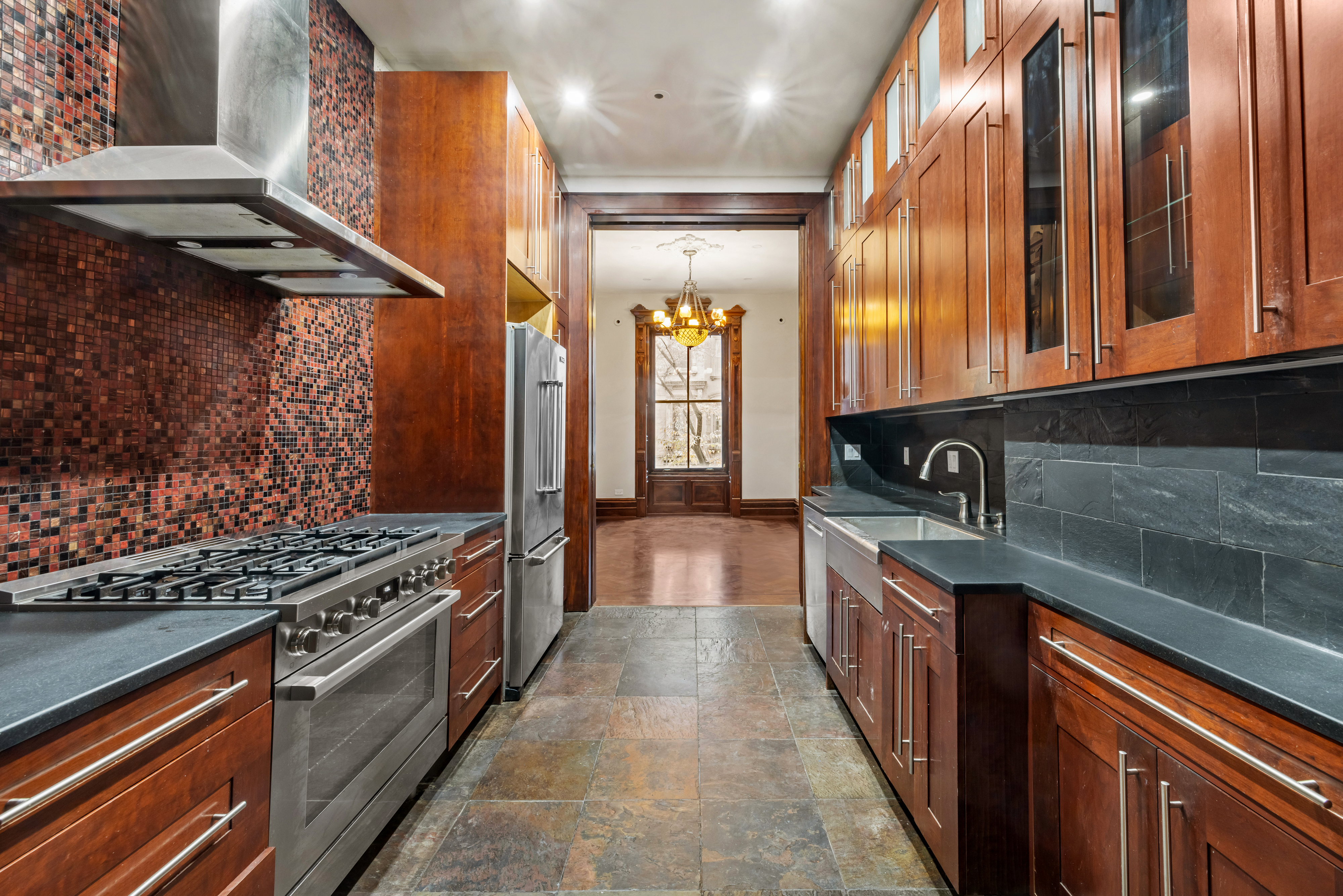 29 East 126th Street, Unit A Manhattan, NY 10035 - Photo 6 of 13 a kitchen with stainless steel appliances granite countertop a stove and a sink