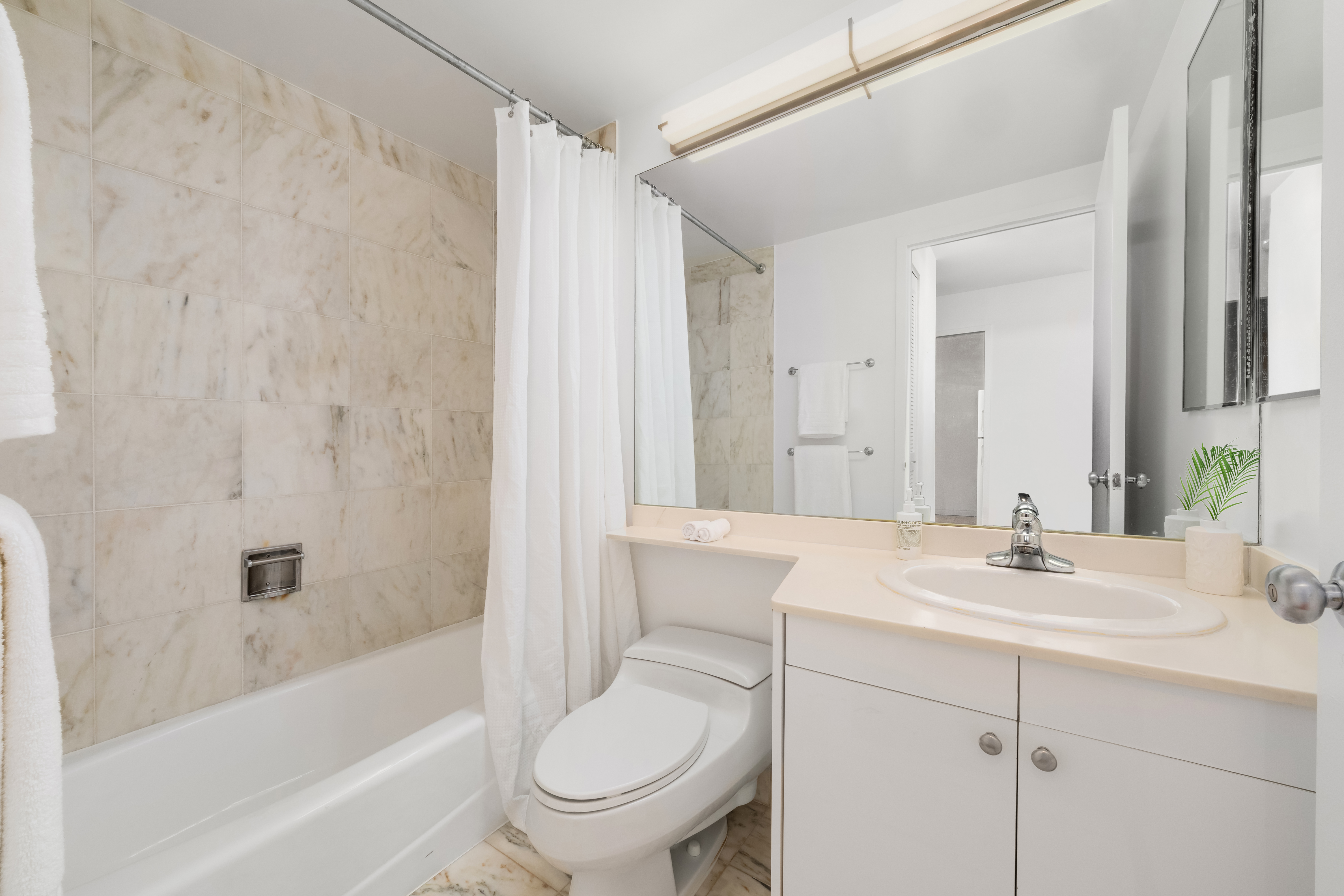 150 East 85th Street, Unit 3F Manhattan, NY 10028 - Photo 10 of 15 a bathroom with a sink toilet and shower