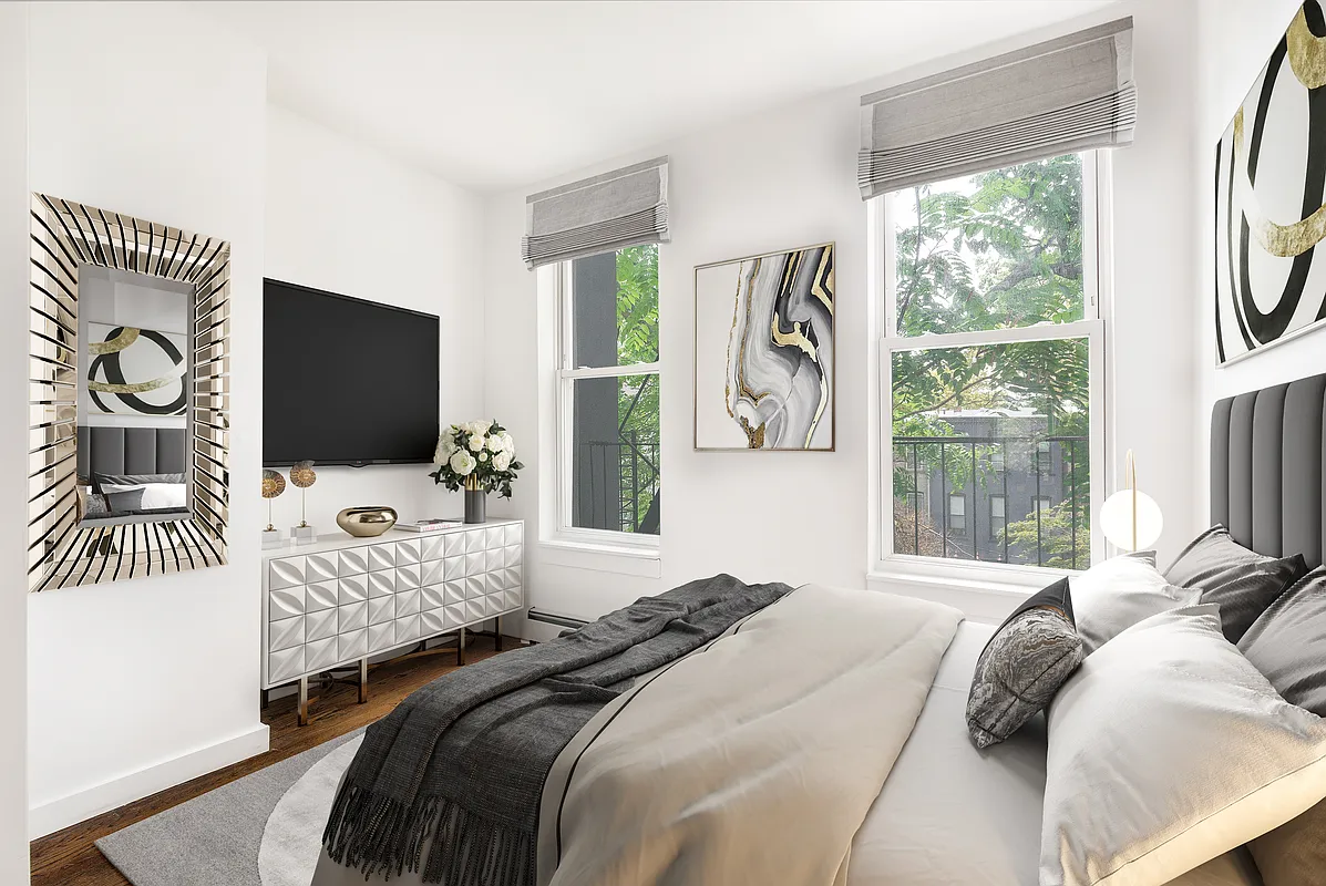 834 Halsey Street, Unit 2 Brooklyn, NY 11233 - Photo 3 of 10 a bedroom with a bed flat screen tv and a large window