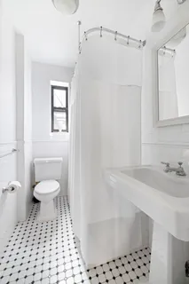 a bathroom with a sink toilet a mirror and shower