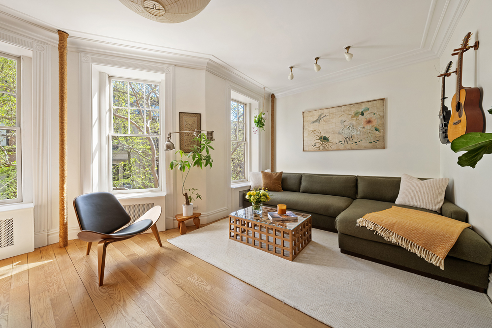 67 Perry Street, Unit 3 Manhattan, NY 10014 - Photo 3 of 22 a living room with furniture and a large window