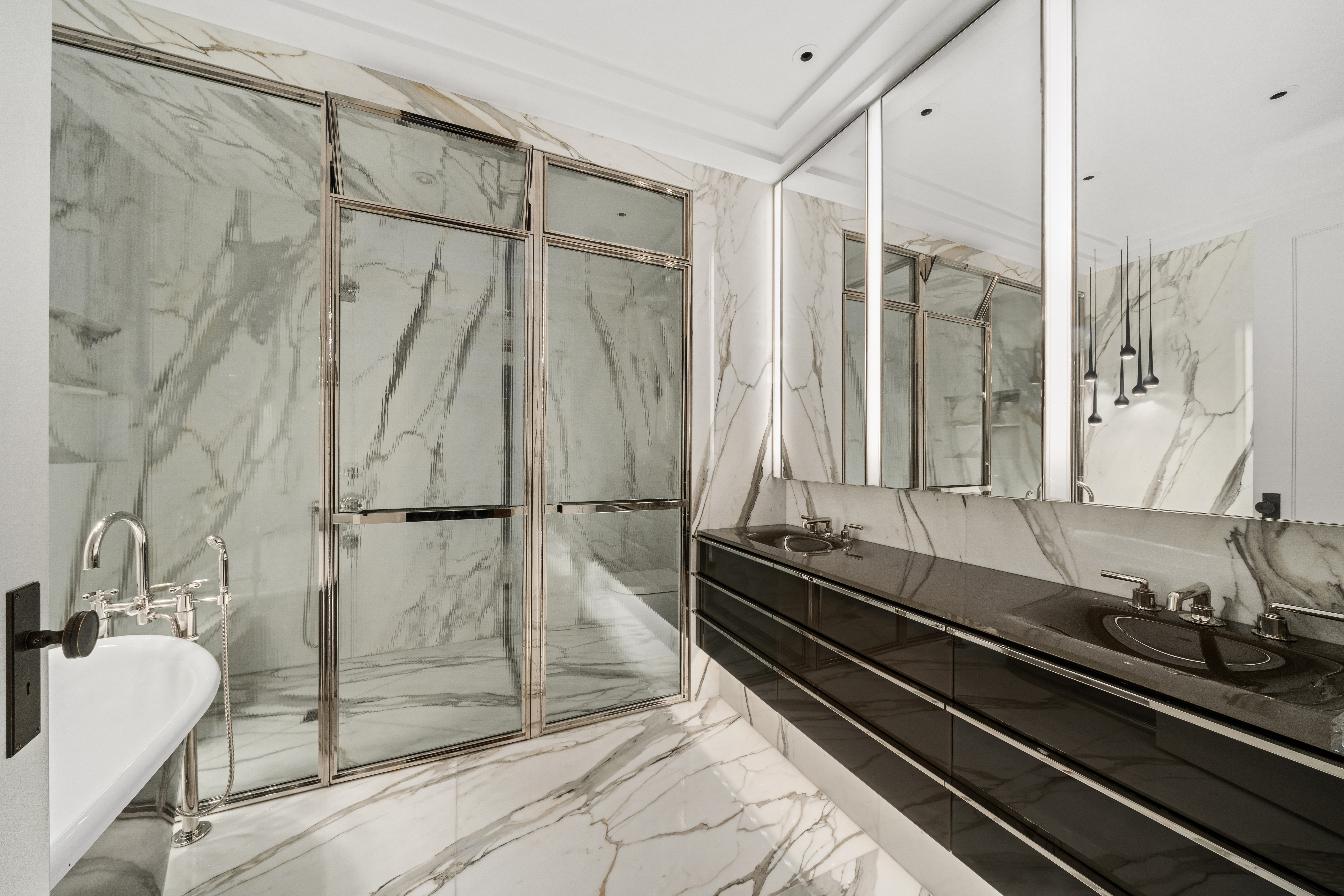 212 West 18th Street, Unit 19C Manhattan, NY 10011 - Photo 11 of 27 a bathroom with a double vanity sink and a mirror