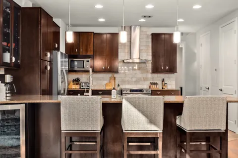 a kitchen with kitchen island cabinets and a refrigerator