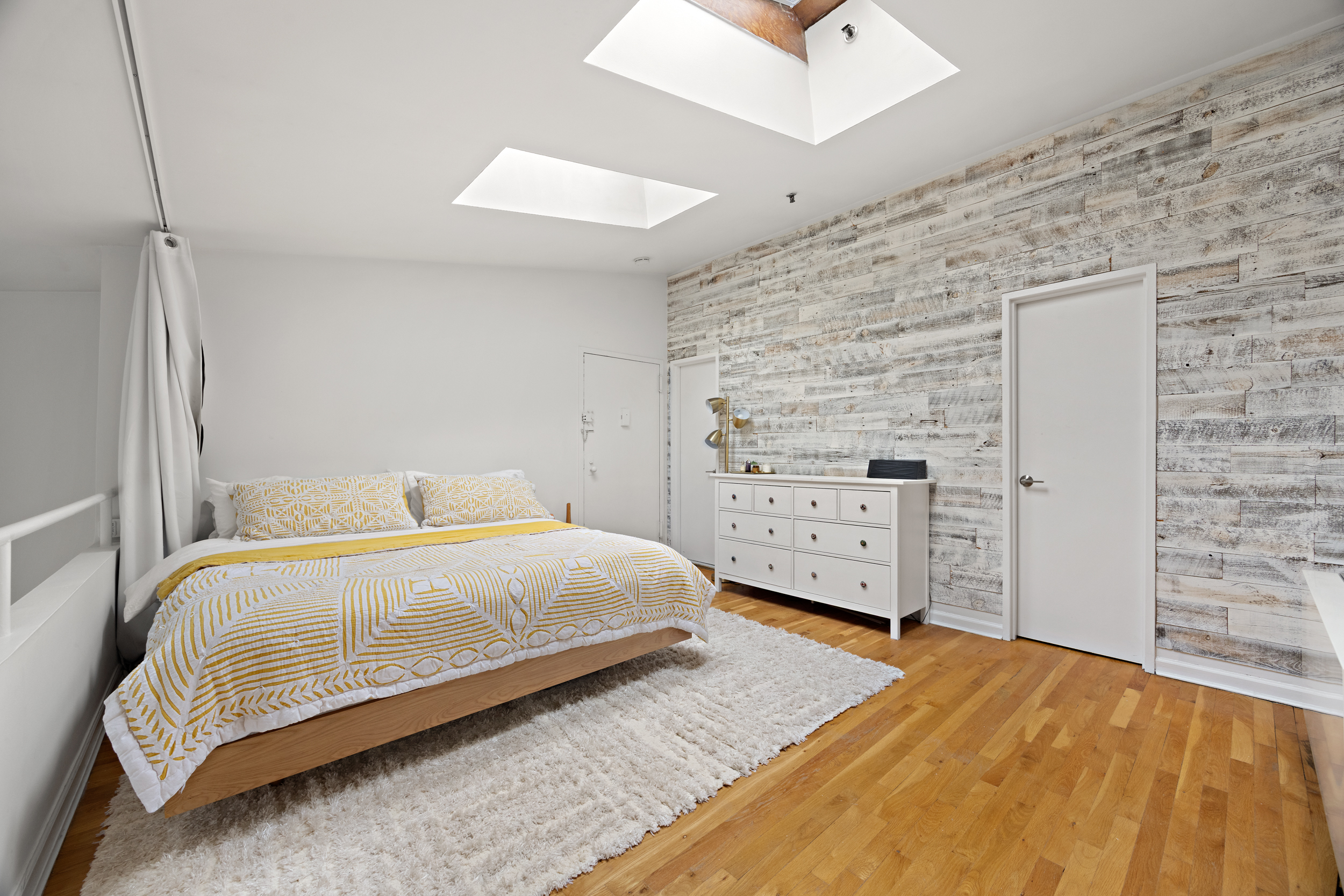 124 Atlantic Avenue, Unit A4H Brooklyn, NY 11201 - Photo 14 of 19 a bedroom with a bed and wooden floor