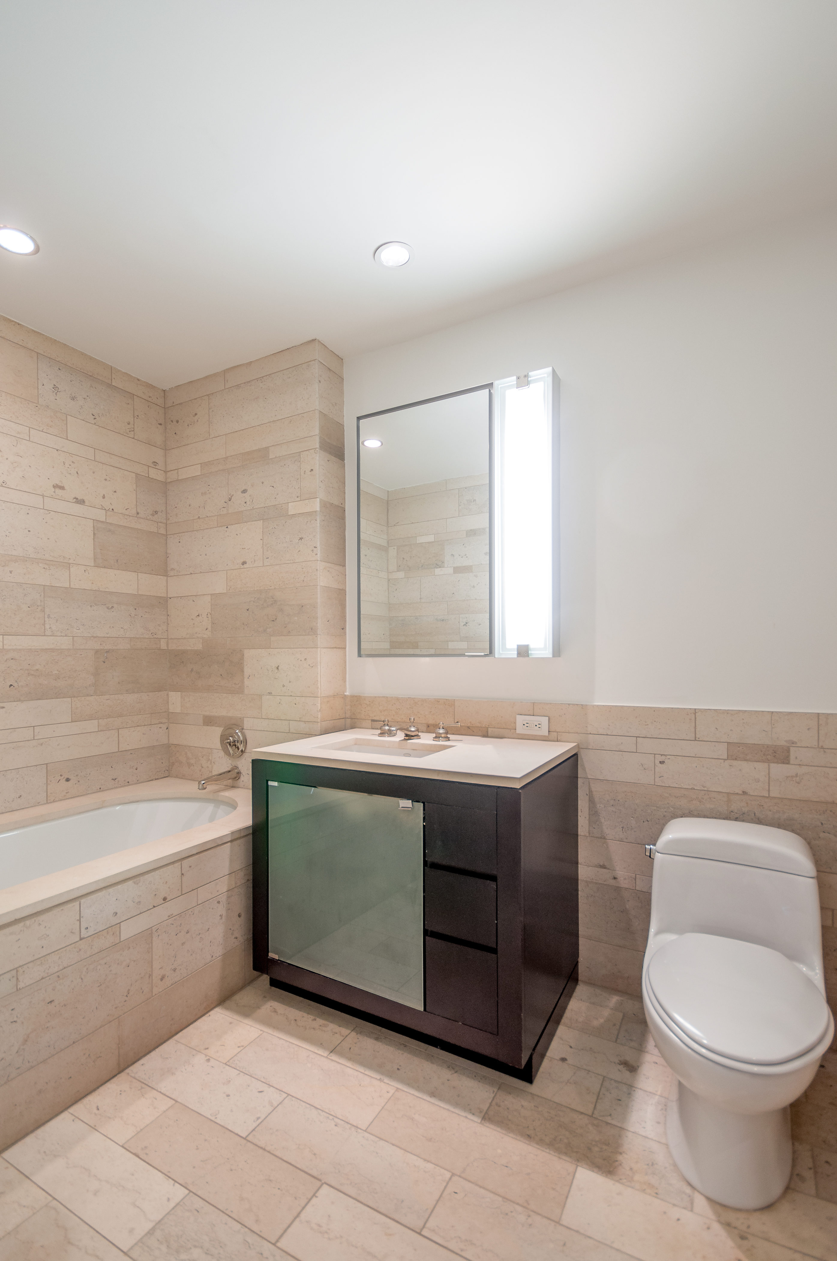 450 East 83rd Street, Unit 3D Manhattan, NY 10028 - Photo 12 of 15 a bathroom with a sink toilet and bathtub