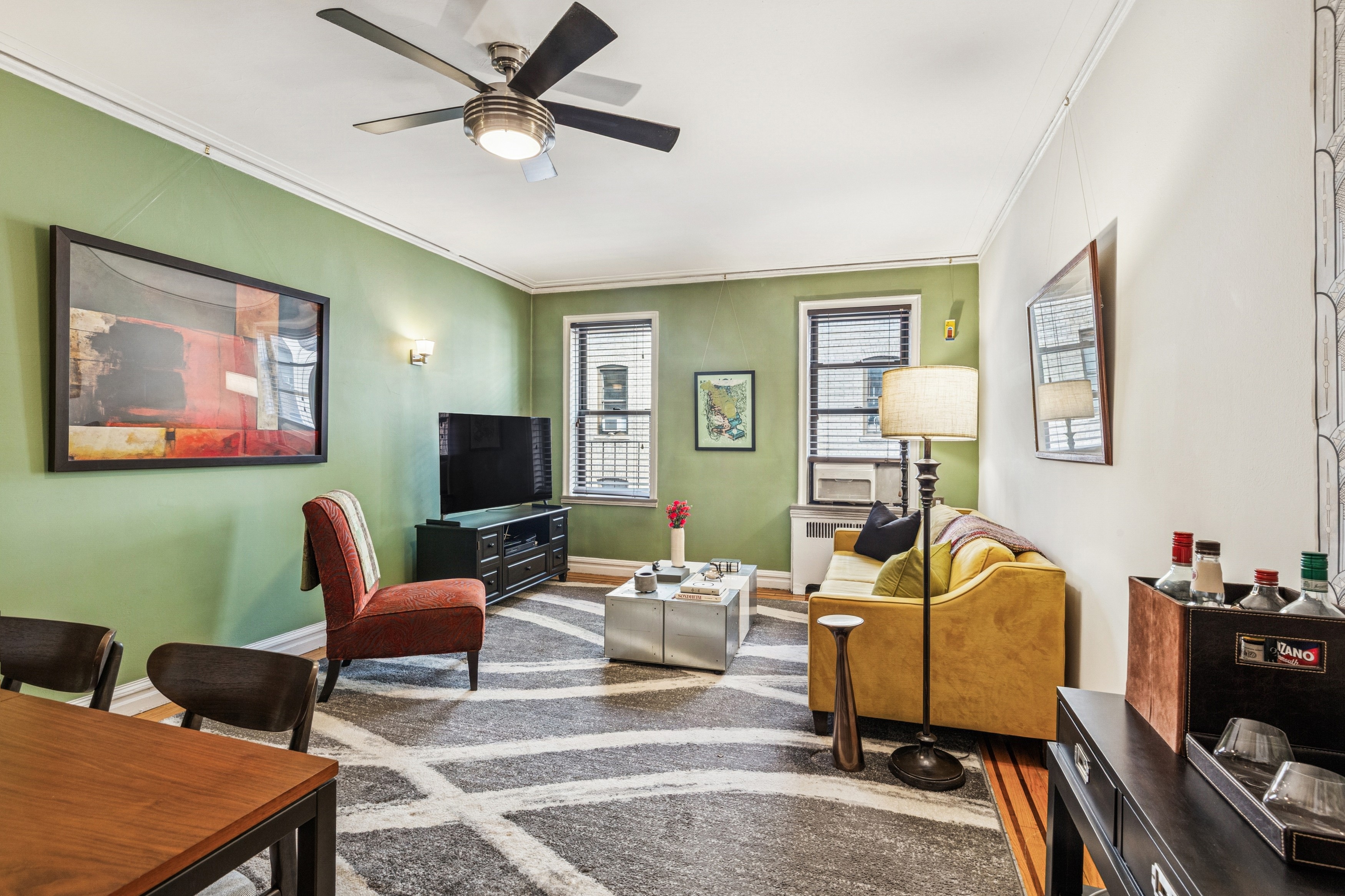 60 Cooper Street, Unit 5J Manhattan, NY 10034 - Photo 2 of 17 a living room with furniture and a flat screen tv