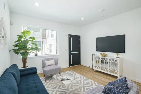 a bedroom with furniture and a flat screen tv