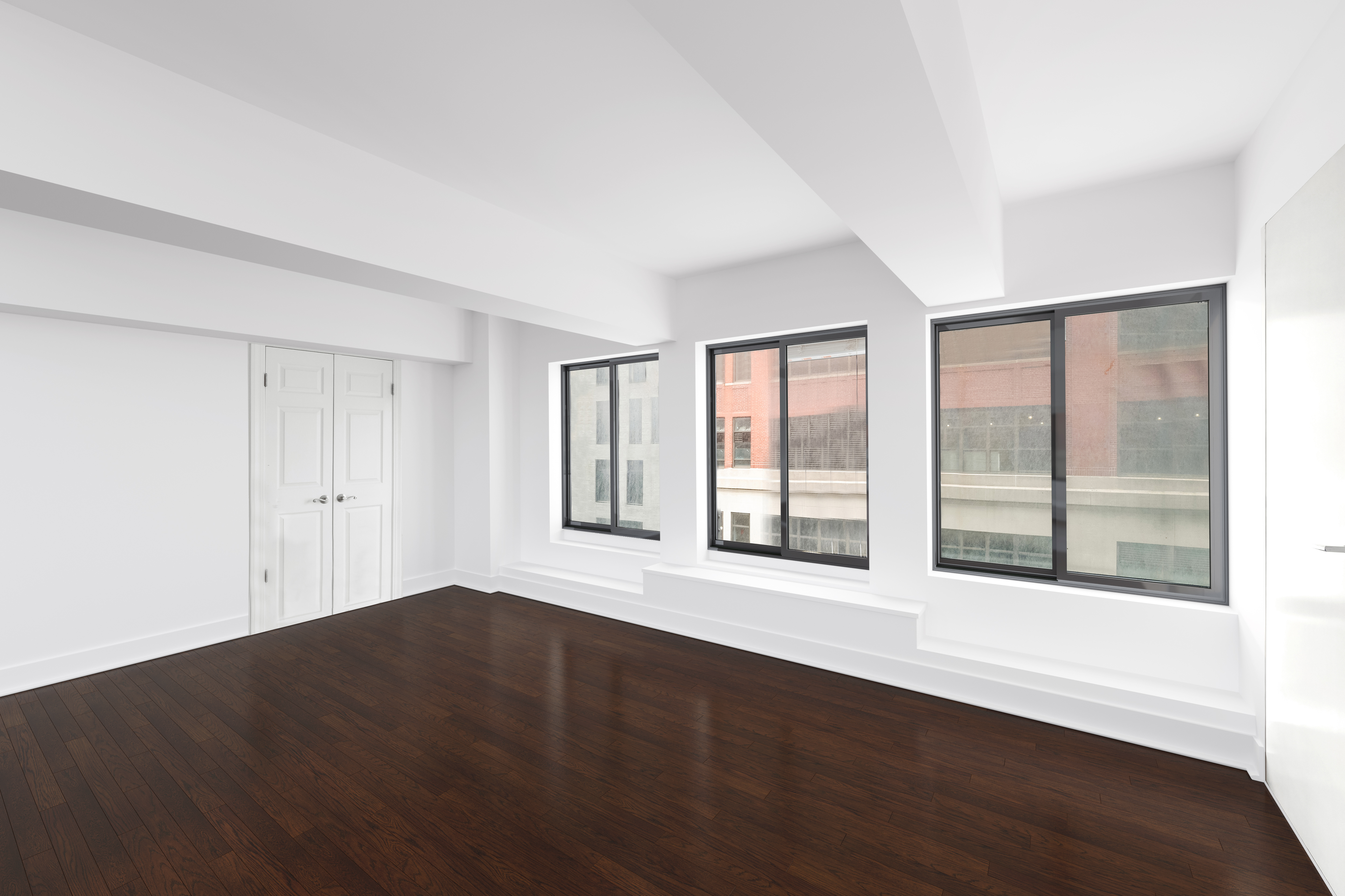 421 Hudson Street, Unit 325 Manhattan, NY 10014 - Photo 9 of 11 a view of an empty room with wooden floor and a window