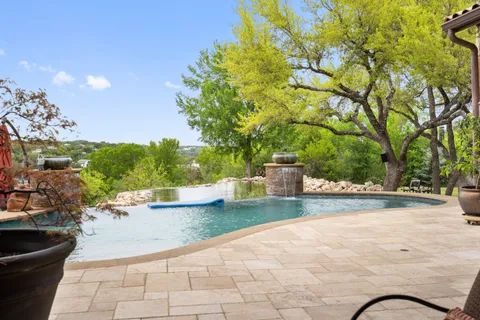 a living room with furniture floor to ceiling window and a flat screen tv