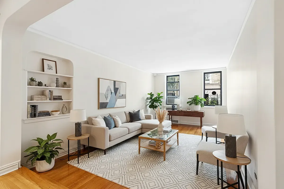 a living room with furniture and a potted plant