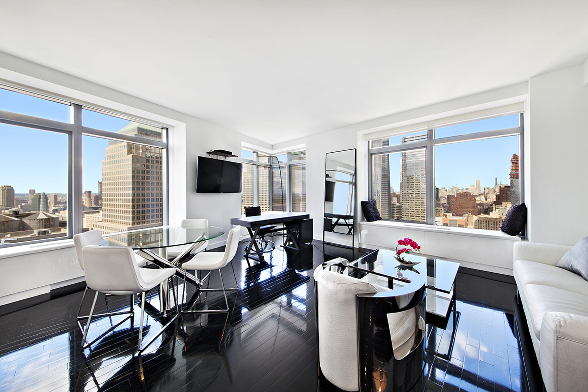 123 Washington Street, Unit 38B Manhattan, NY 10006 - Photo 1 of 9 a view of a dining room with furniture window and outside view