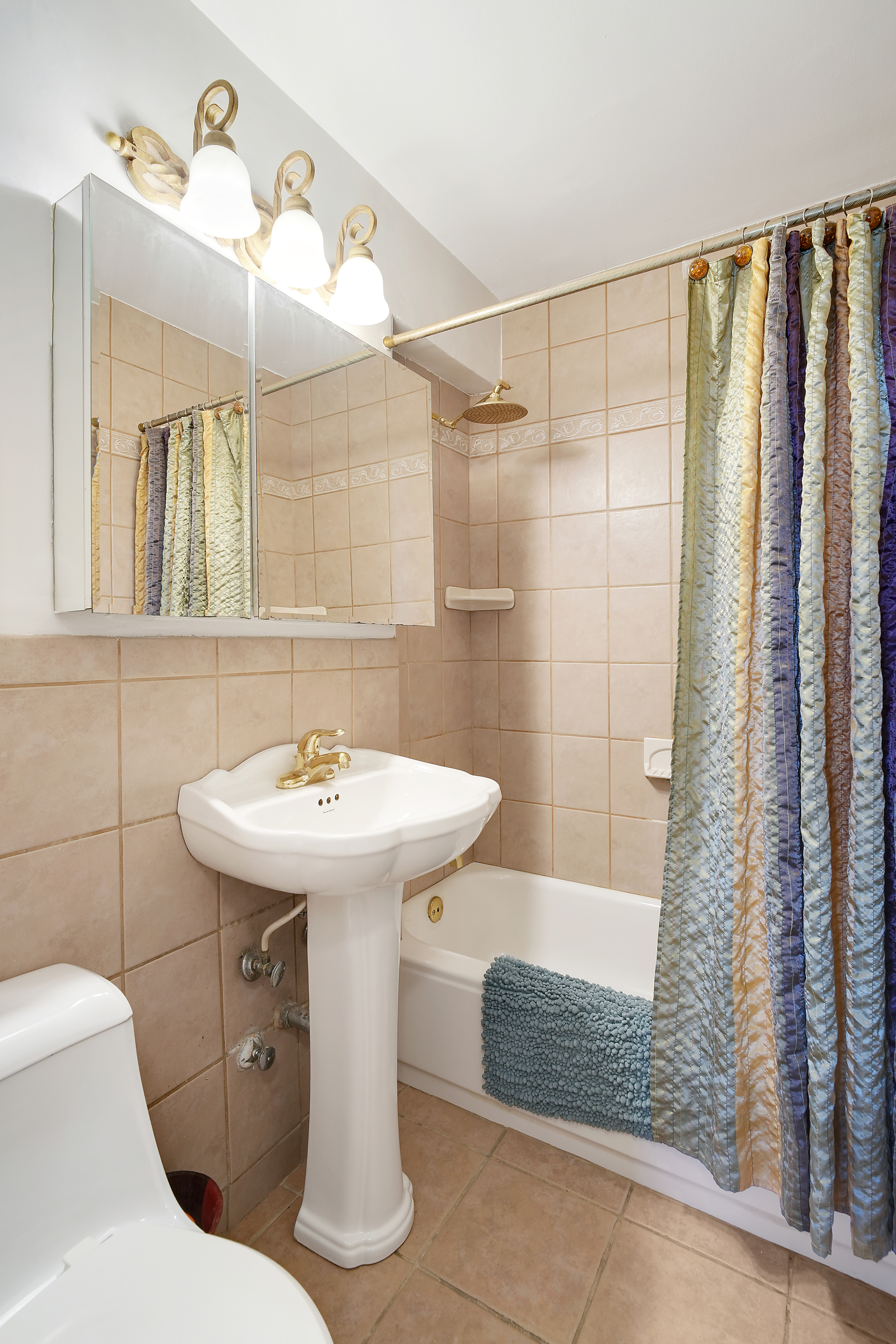 5700 Arlington Avenue, Unit 16T Bronx, NY 10471 - Photo 9 of 16 a bathroom with a sink a toilet and shower