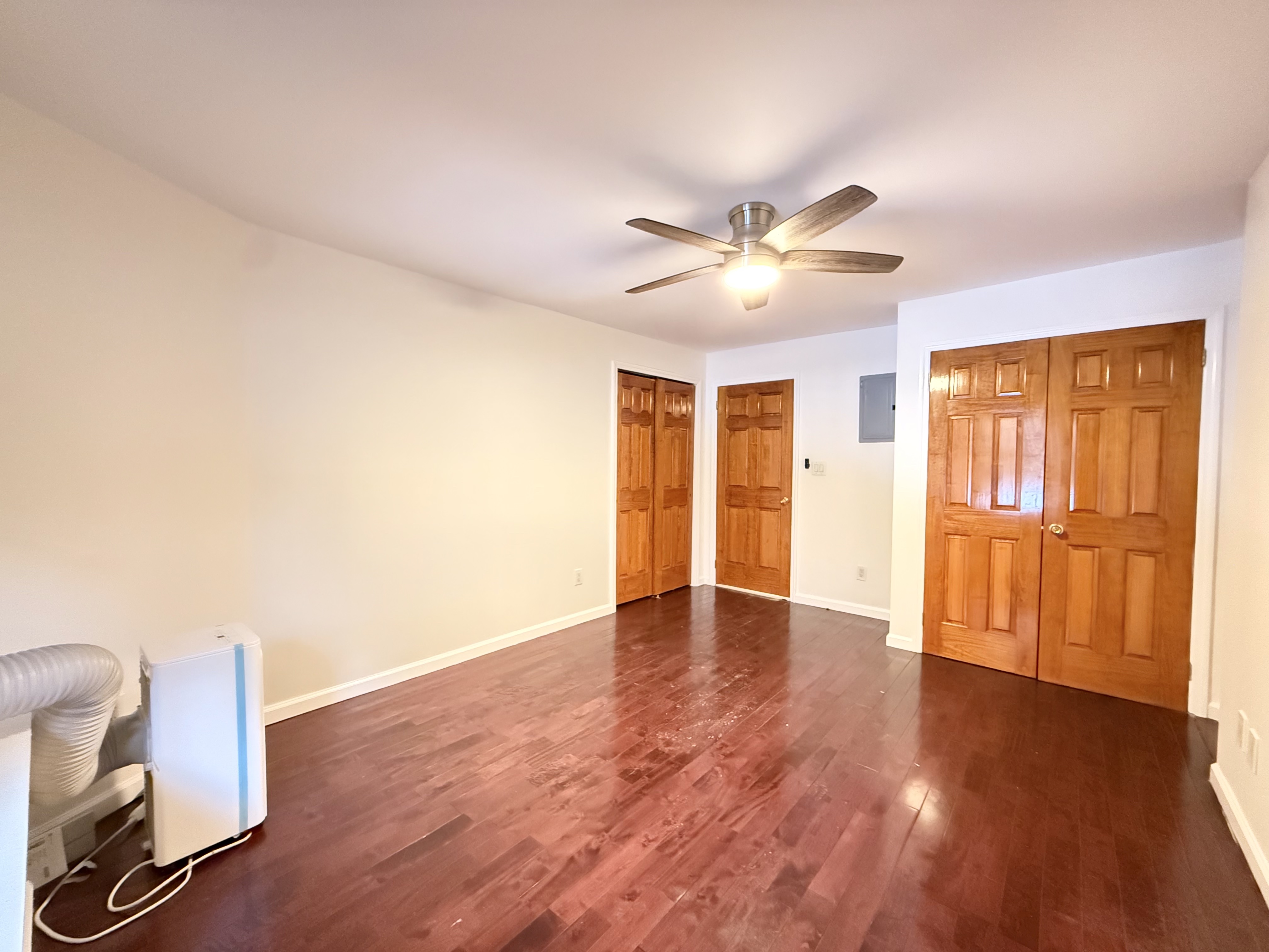 433 West 162nd Street, Unit 1 Manhattan, NY 10032 - Photo 8 of 13 a view of an empty room with a window and wooden floor
