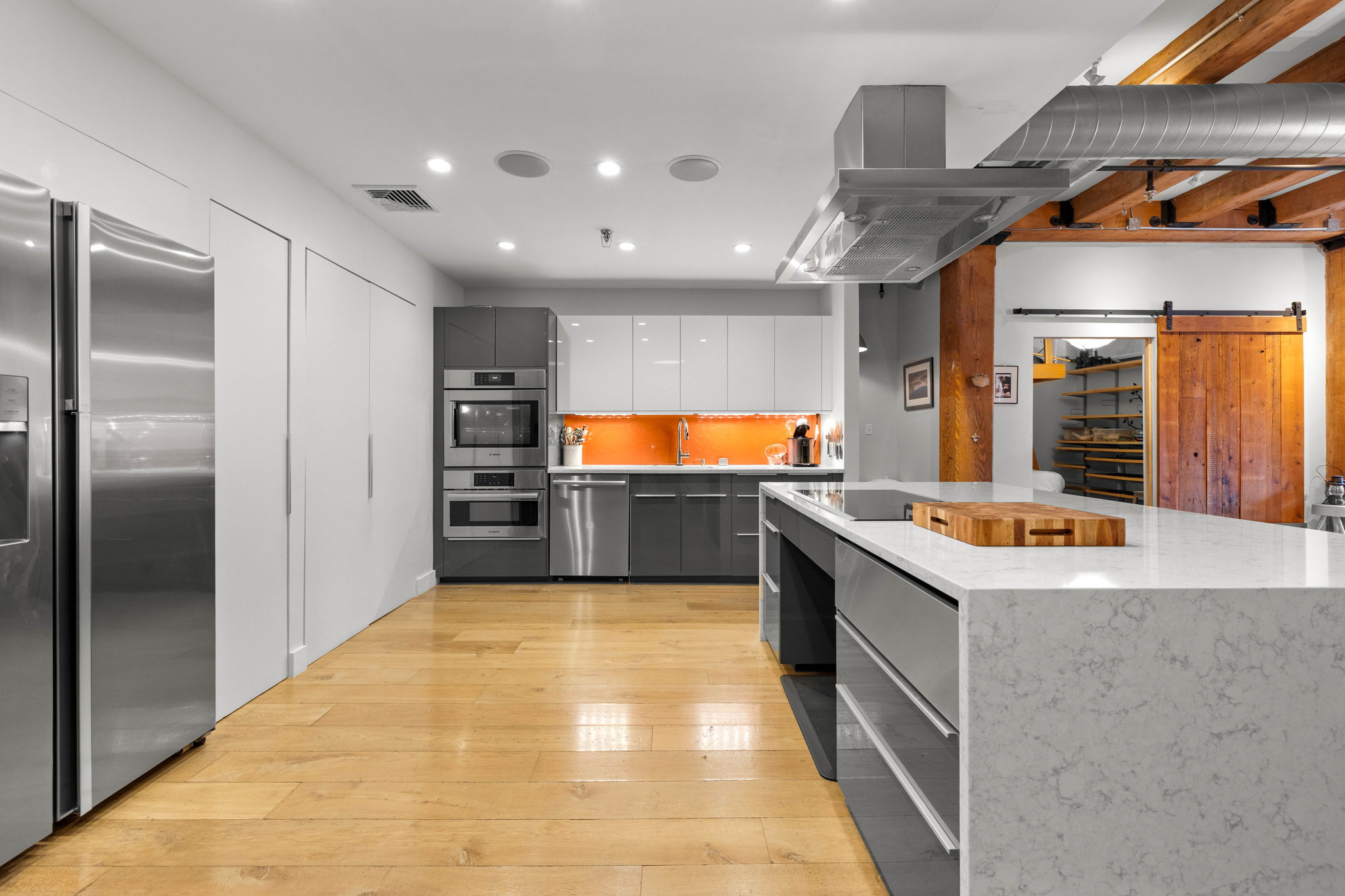 33 Sleeper Street, Unit 307 Boston, MA 02210 - Photo 3 of 15 a kitchen with stainless steel appliances granite countertop a sink and a refrigerator