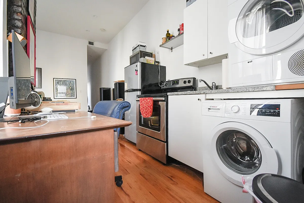 199 Java Street Brooklyn, NY 11222 - Photo 23 of 32 a living room with stainless steel appliances furniture a rug and a view of kitchen