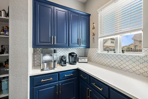 a kitchen with cabinets and window