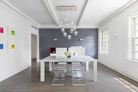 a view of a dining room with furniture and chandelier