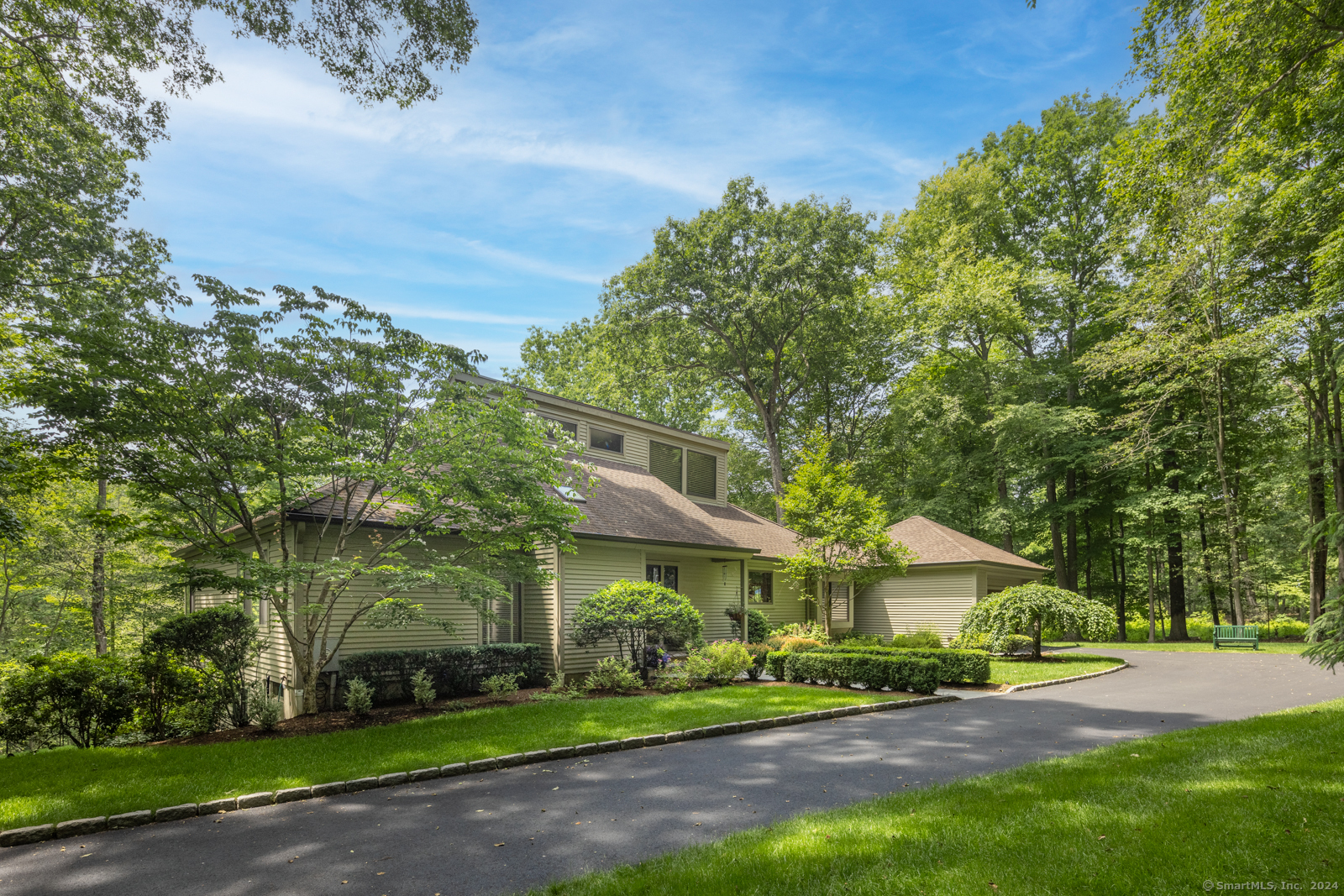 13 Bittersweet Road Weston, CT 06883 - Photo 25 of 35 a view of a big yard in front of a brick house with large windows